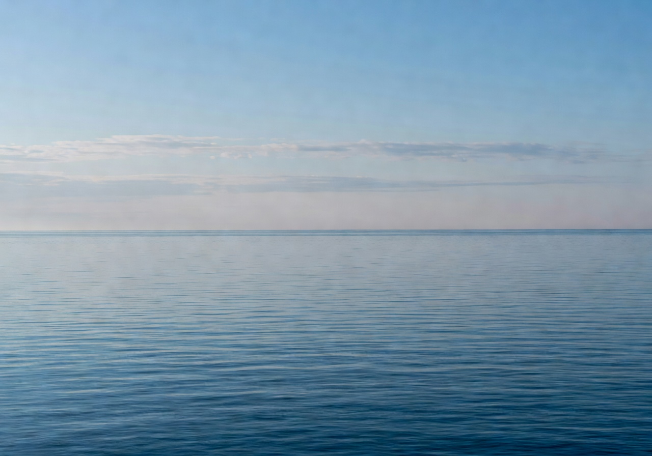 Long horizon at sea with soft cloud line